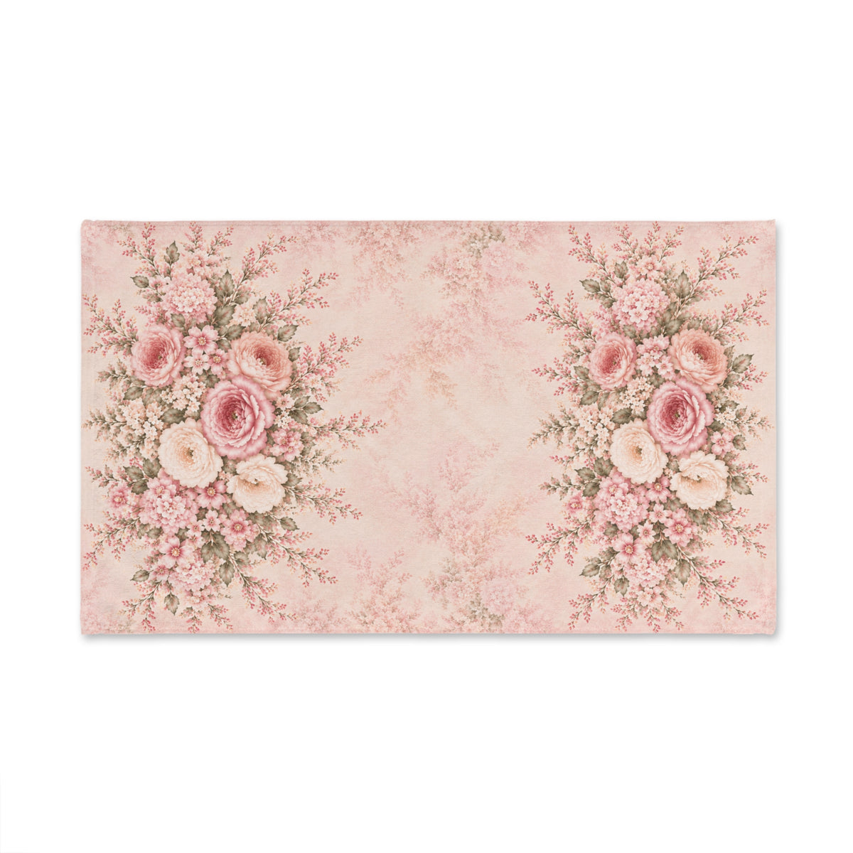A rectangular decorative hand towel with a vintage floral design in soft pink and cream tones, featuring two large rose bouquets on the left and right sides and a faded damask pattern in the center, shown on a plain white background.