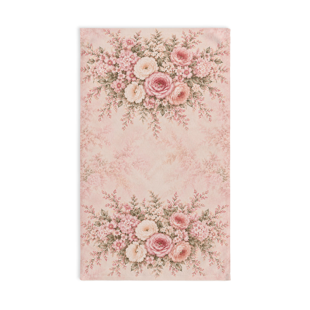 A rectangular pink hand towel featuring a vintage floral pattern with two large rose bouquets at the top and bottom on a light blush background.