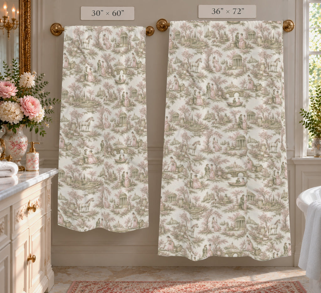 Two large bath towels with a classic toile de Jouy pattern in blush pink and sage green on a white background hanging on gold rods in a bathroom. The left curtain is labeled 30" x 60" and the right curtain is labeled 36" x 72".